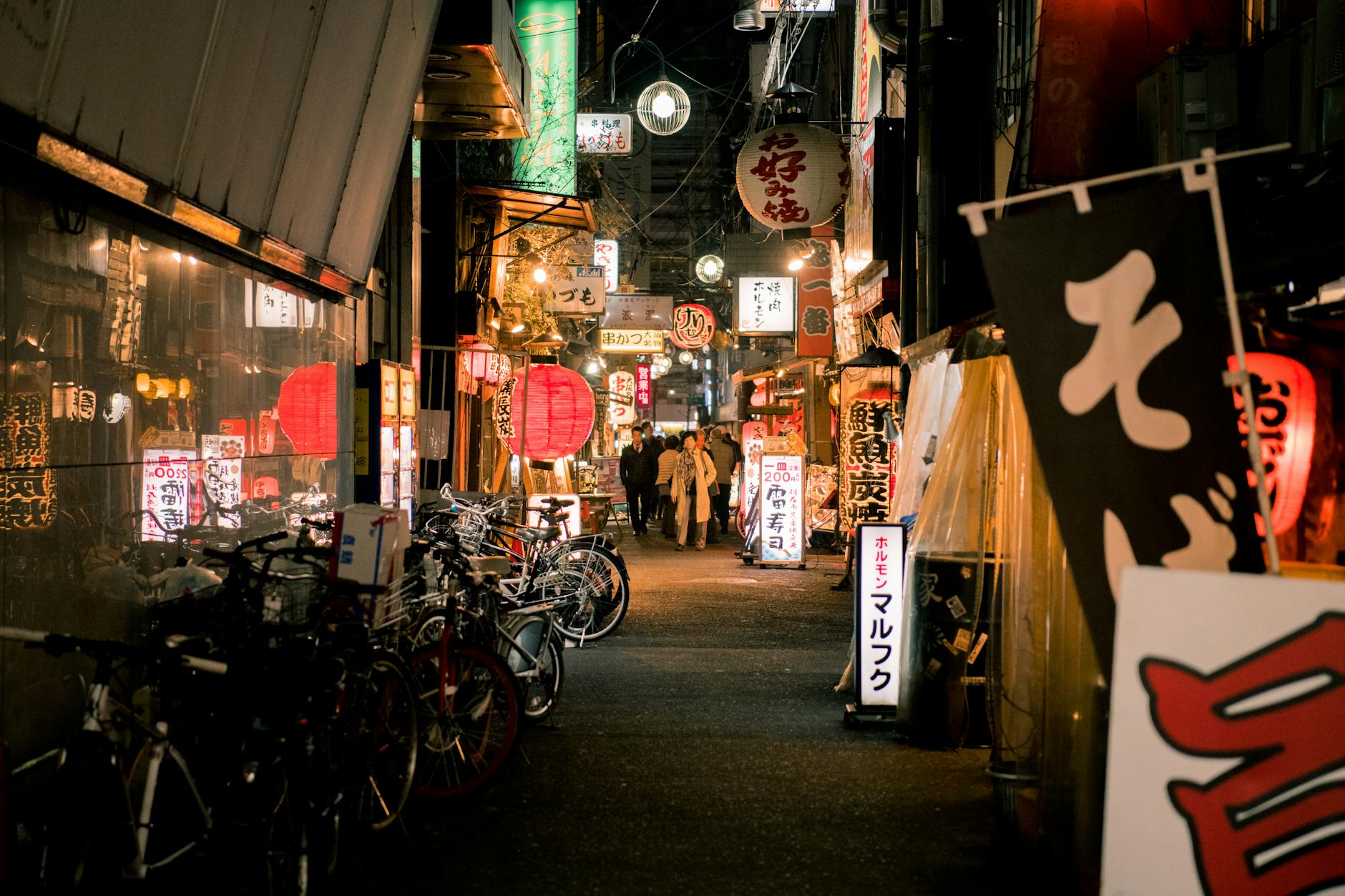 bicycles parked near japanese store during night time